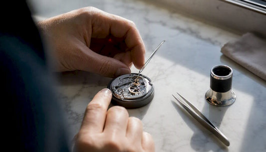 Watchmaker fitting click spring in watch movement