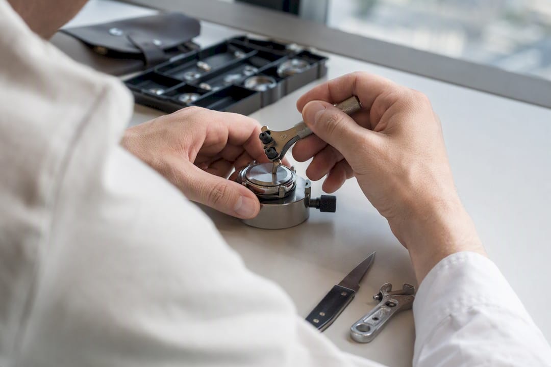 Watchmaker opening luxury watch case back