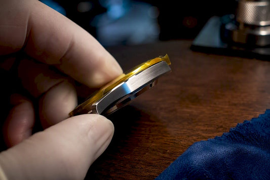 Taped stainless steel watch chamfer close-up
