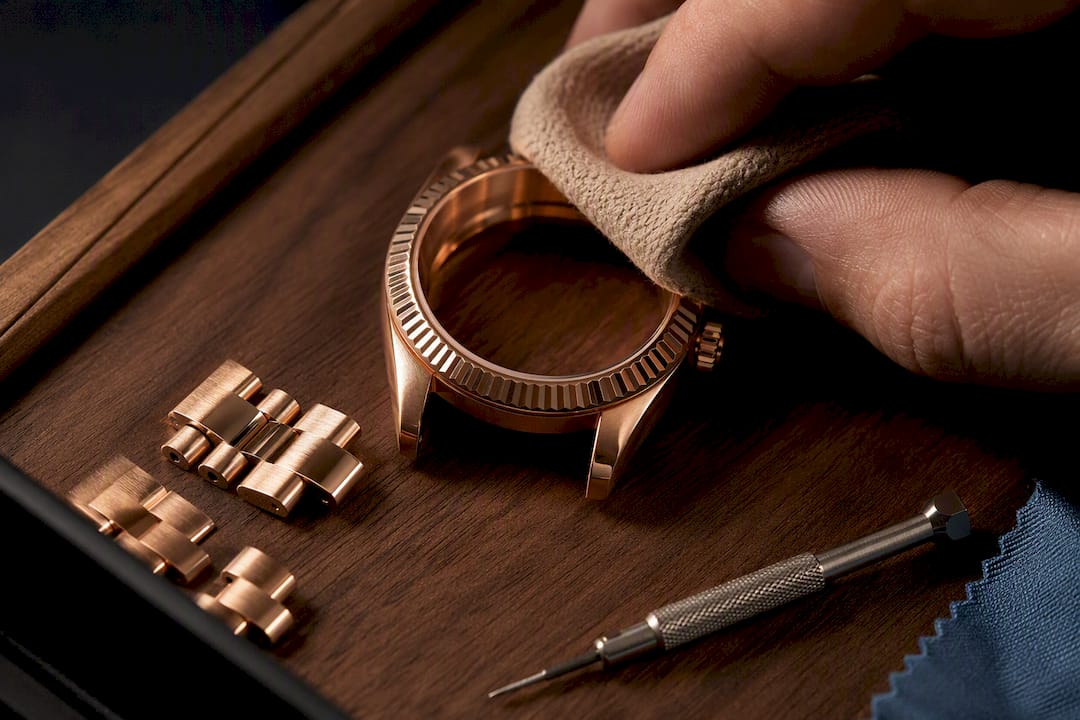 Cropped rose gold case being carefully wiped