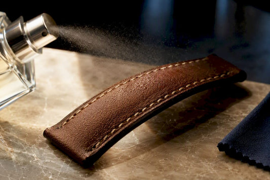 Perfume mist reaching a leather watch strap