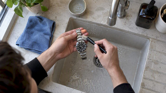 Collector cleaning a stainless-steel Oyster bracelet