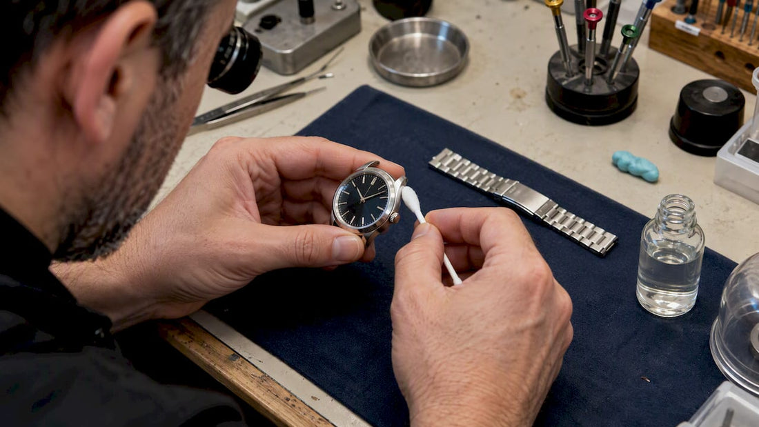 Watch case being wiped with alcohol